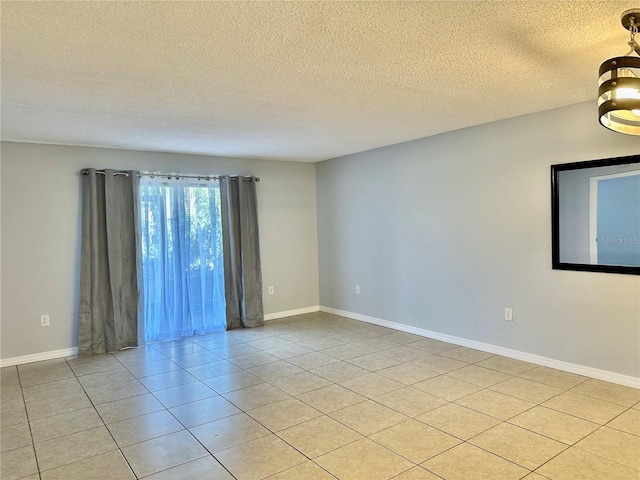 unfurnished room featuring light tile patterned flooring and a textured ceiling