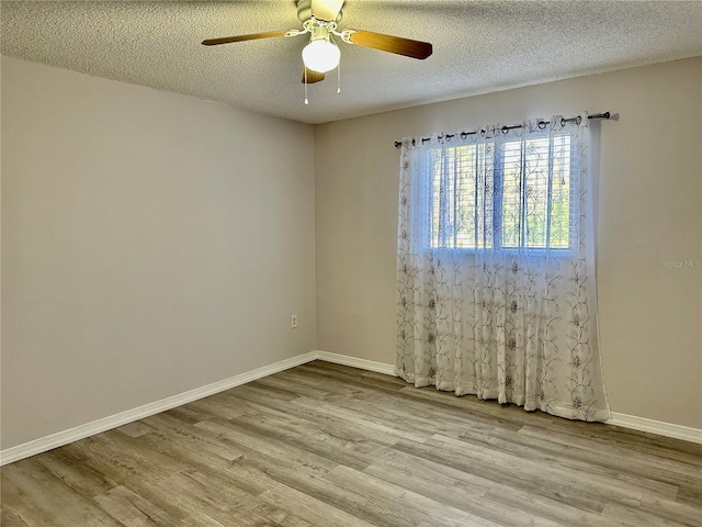 spare room featuring ceiling fan, a textured ceiling, and light wood-type flooring