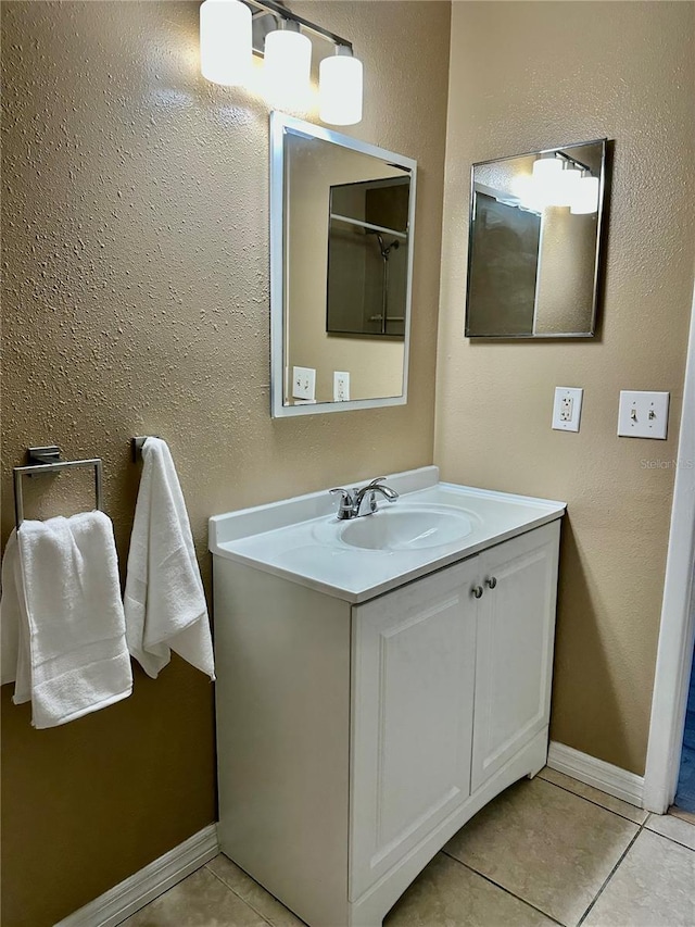 bathroom featuring tile patterned flooring and vanity