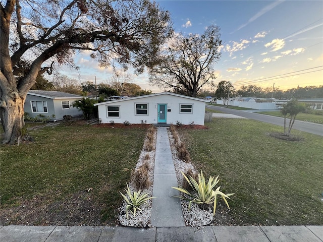 view of front of house with a yard