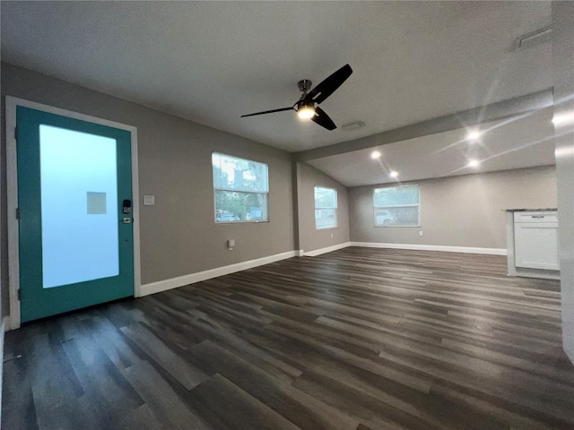 unfurnished living room featuring dark wood-type flooring, ceiling fan, and vaulted ceiling