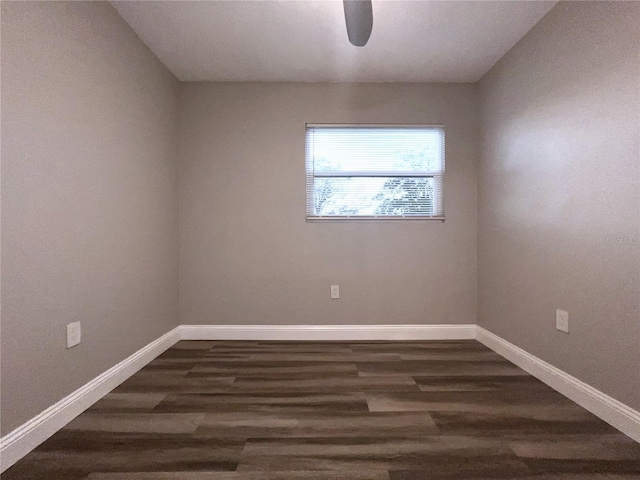 unfurnished room with dark hardwood / wood-style flooring