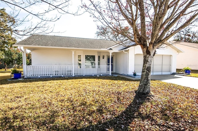 ranch-style house featuring covered porch, a garage, and a front lawn