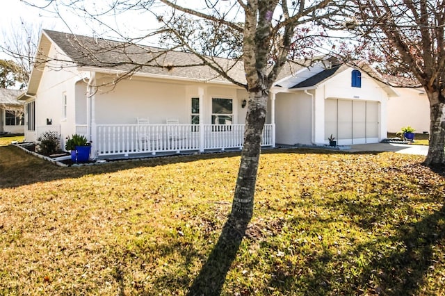 ranch-style home with a garage and a front lawn