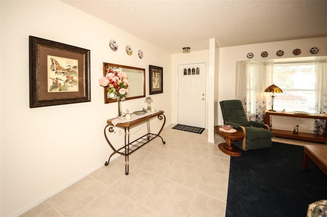 tiled entrance foyer featuring a textured ceiling