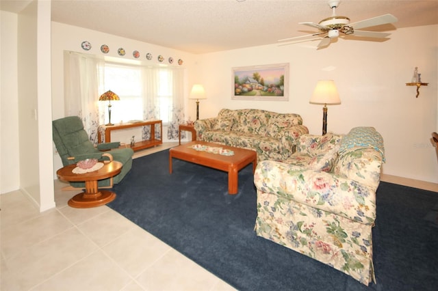 tiled living room with ceiling fan and a textured ceiling