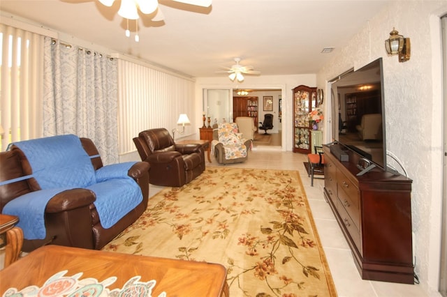 living room with ceiling fan and light tile patterned floors