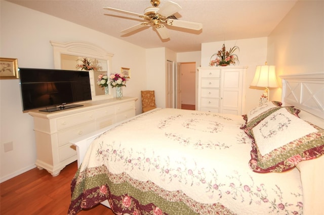 bedroom with ceiling fan, wood-type flooring, and a textured ceiling