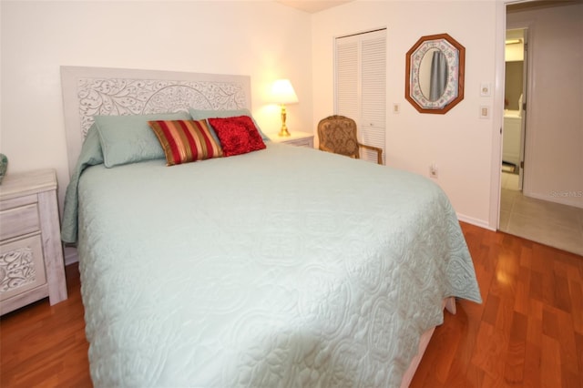 bedroom with hardwood / wood-style floors and a closet