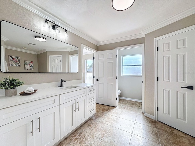 bathroom featuring ornamental molding, vanity, toilet, and a textured ceiling