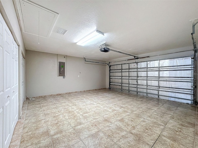 garage with electric panel and a garage door opener