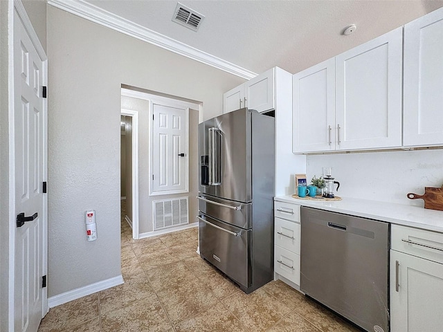 kitchen with white cabinets, crown molding, and stainless steel appliances