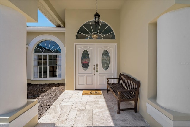 entrance to property with stucco siding