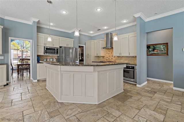 kitchen featuring baseboards, wall chimney exhaust hood, a kitchen island, stainless steel appliances, and stone tile flooring