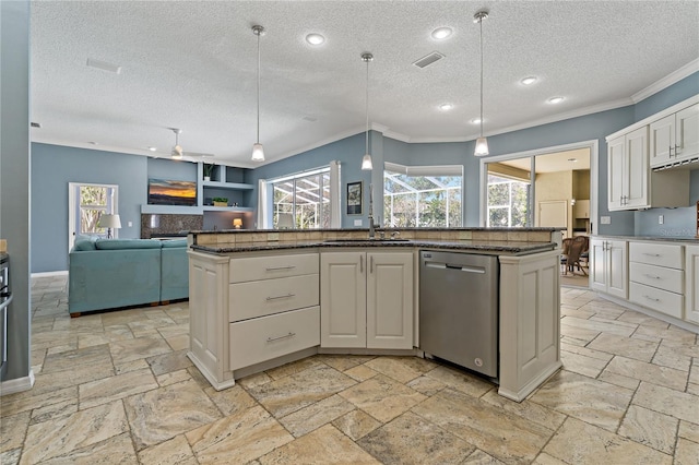 kitchen with stone tile floors, a sink, visible vents, dishwasher, and crown molding