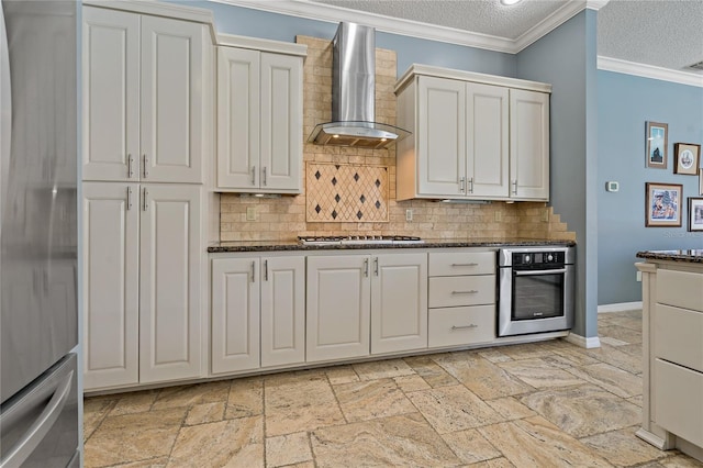 kitchen featuring crown molding, tasteful backsplash, appliances with stainless steel finishes, a textured ceiling, and wall chimney exhaust hood