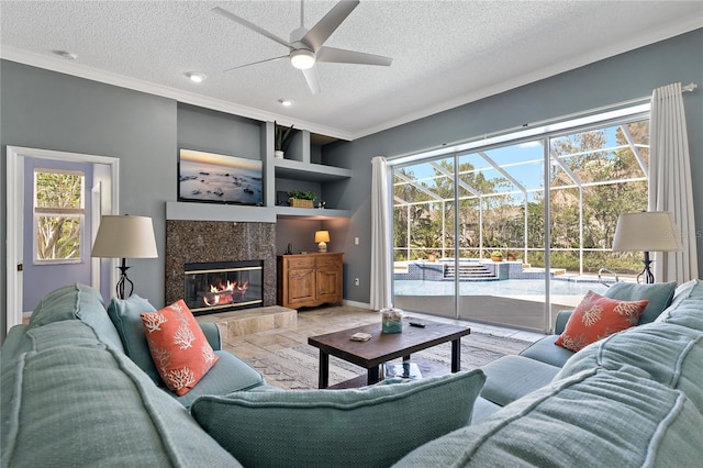 living room with plenty of natural light, a fireplace, and a textured ceiling