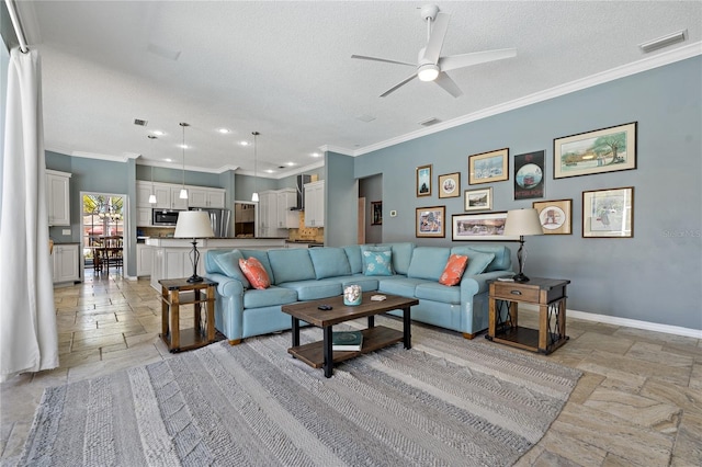 living room featuring crown molding, stone tile flooring, visible vents, a textured ceiling, and baseboards