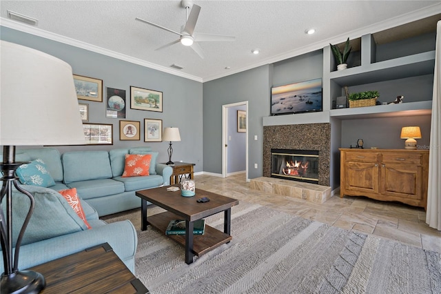 living room with visible vents, ornamental molding, and a textured ceiling