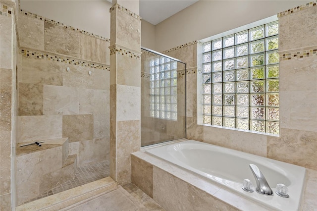 full bathroom with a garden tub and tiled shower