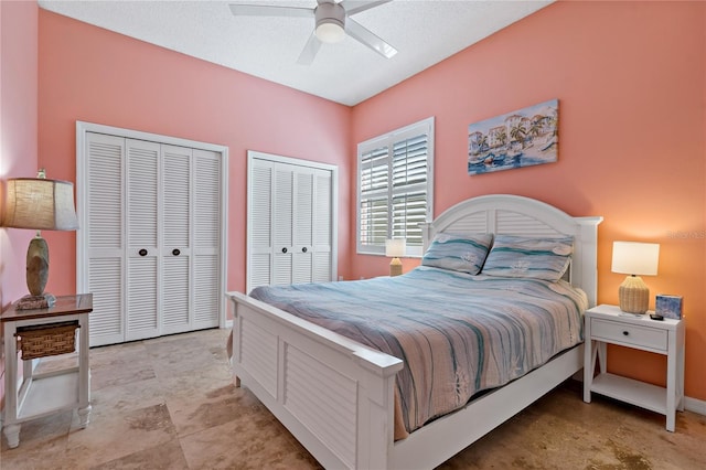 bedroom featuring ceiling fan, baseboards, and multiple closets