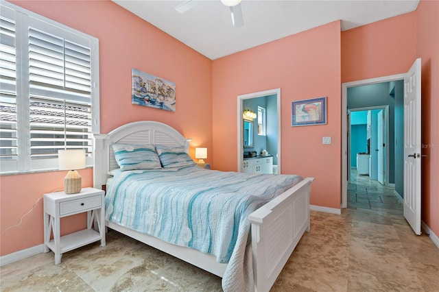 bedroom with a ceiling fan, baseboards, and connected bathroom