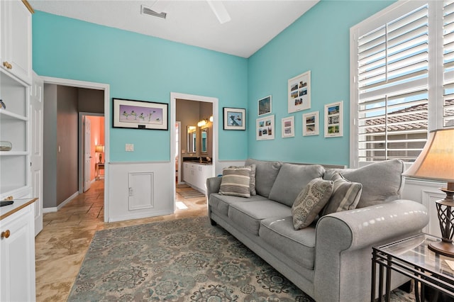 living room featuring stone finish flooring and visible vents