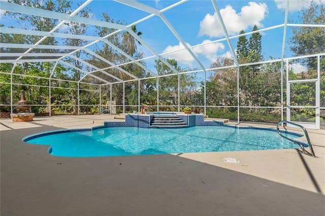 view of pool with a lanai, a patio area, and a pool with connected hot tub