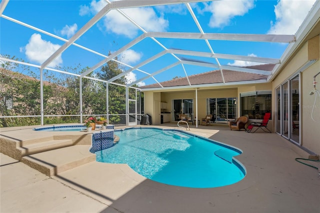 outdoor pool featuring a lanai, a patio, and an in ground hot tub