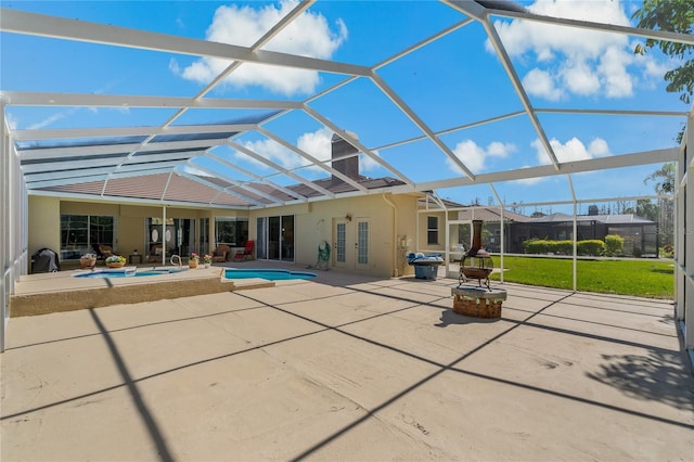 rear view of property featuring an outdoor pool, glass enclosure, french doors, a patio area, and stucco siding