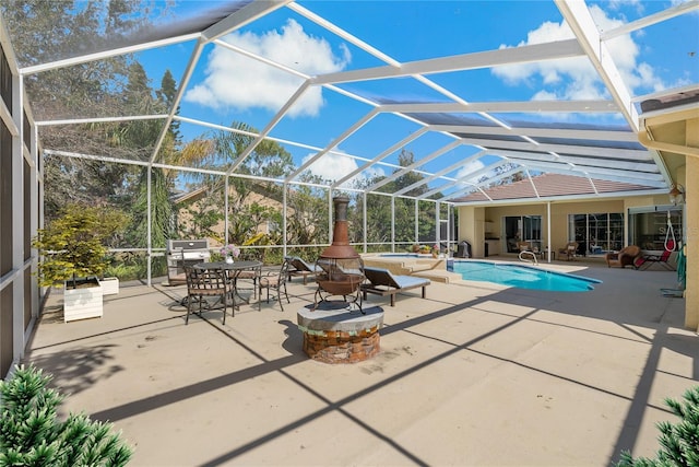 outdoor pool featuring a patio, glass enclosure, and an in ground hot tub