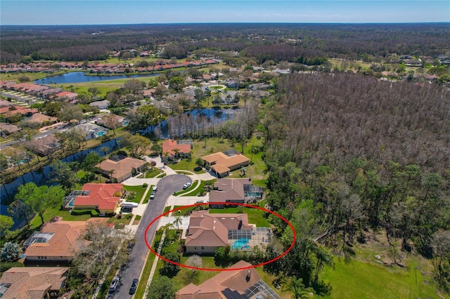 aerial view featuring a water view, a residential view, and a wooded view