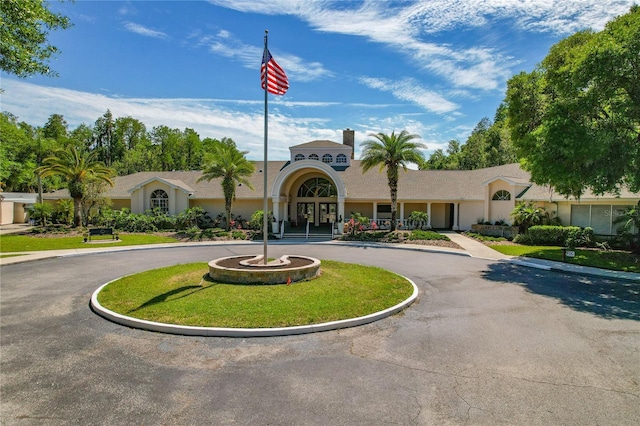 view of property with curved driveway