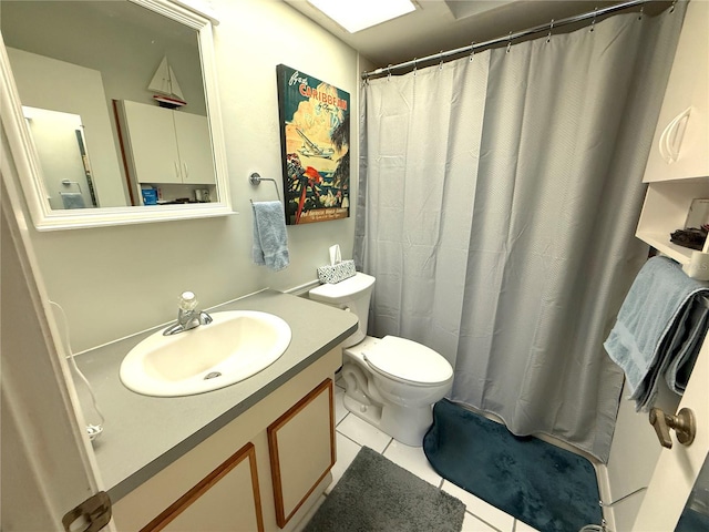 bathroom featuring toilet, tile patterned floors, and vanity