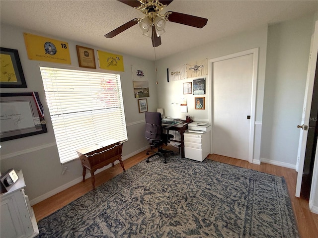 office space featuring a textured ceiling, hardwood / wood-style flooring, and ceiling fan