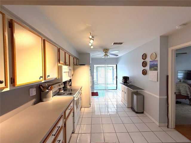 kitchen featuring white appliances, light tile patterned floors, and ceiling fan