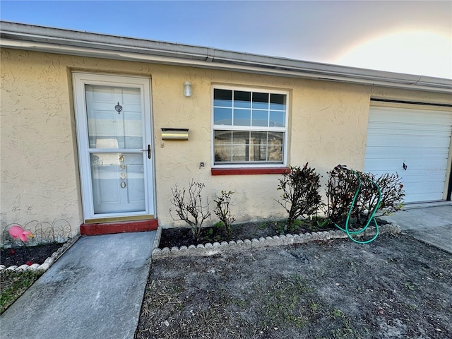 doorway to property with a garage