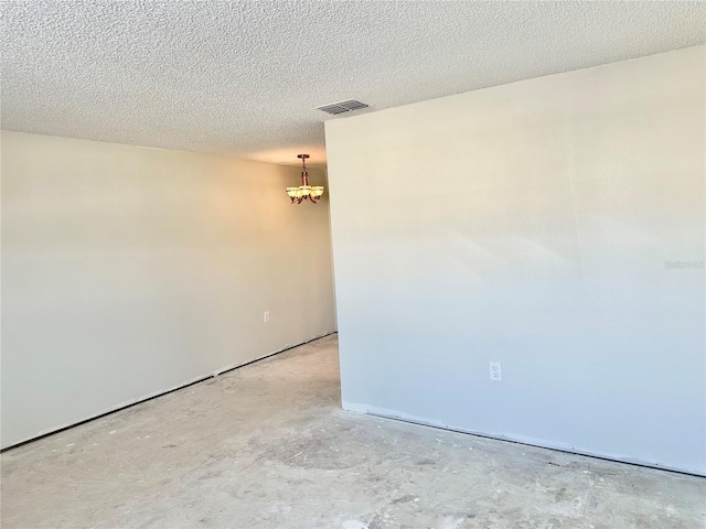 empty room featuring a textured ceiling