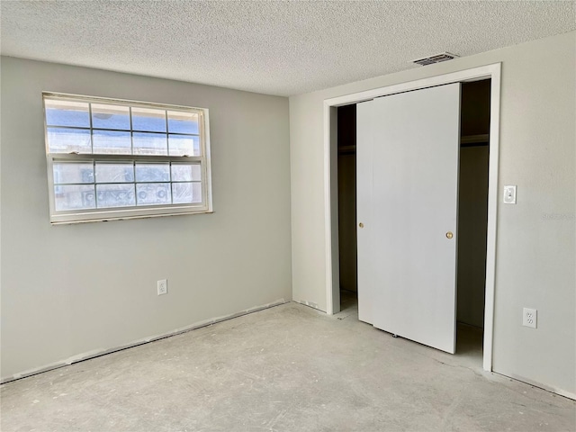 unfurnished bedroom featuring a closet and a textured ceiling