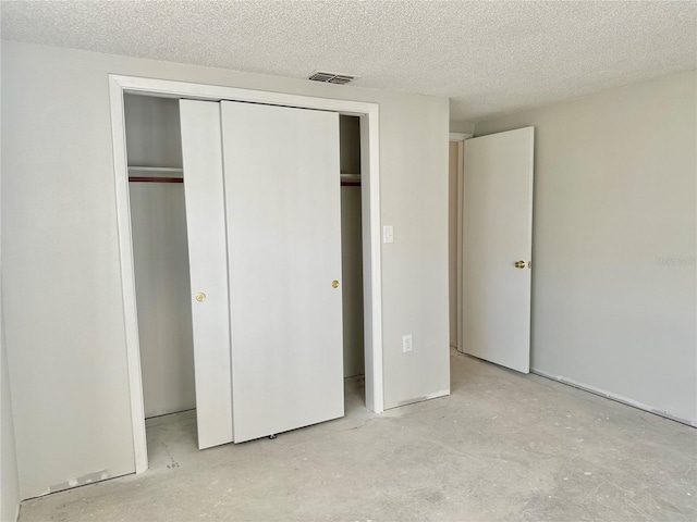 unfurnished bedroom with a closet and a textured ceiling