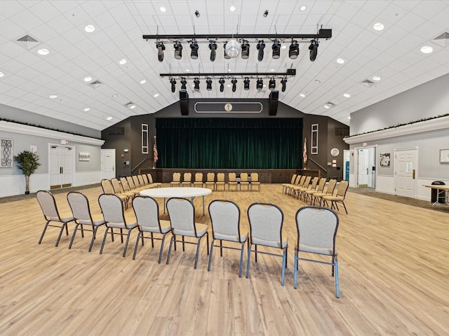 miscellaneous room featuring light wood-style flooring, visible vents, and vaulted ceiling