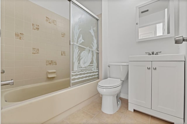 full bathroom with baseboards, combined bath / shower with glass door, toilet, vanity, and tile patterned flooring