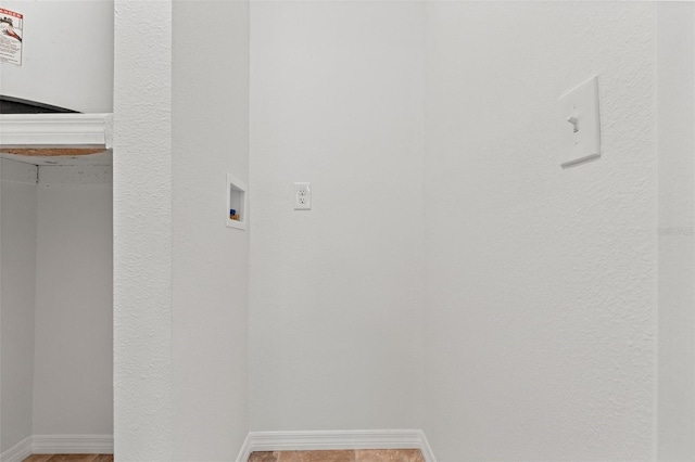 laundry room with baseboards, laundry area, and hookup for a washing machine