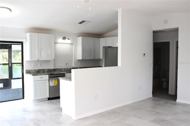 kitchen with a sink, visible vents, appliances with stainless steel finishes, and white cabinetry