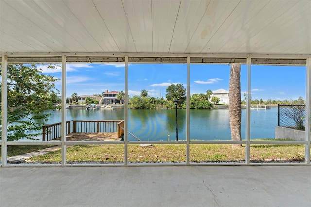 unfurnished sunroom with a water view