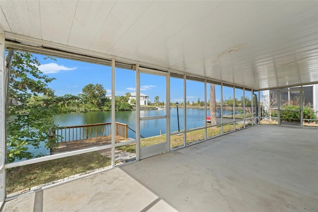 unfurnished sunroom featuring a water view