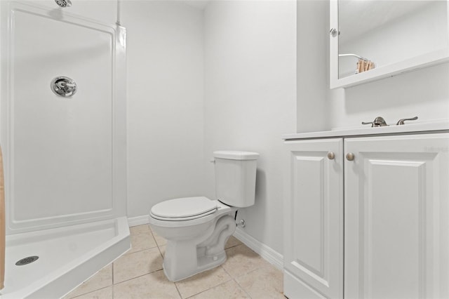 bathroom with tile patterned flooring, toilet, a stall shower, and baseboards