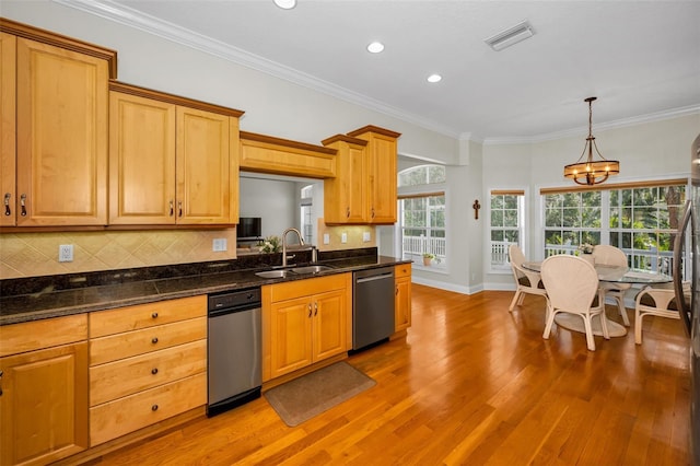 kitchen with pendant lighting, a notable chandelier, backsplash, stainless steel dishwasher, and a sink