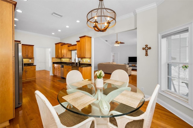 dining area with a wealth of natural light, visible vents, dark wood finished floors, and baseboards