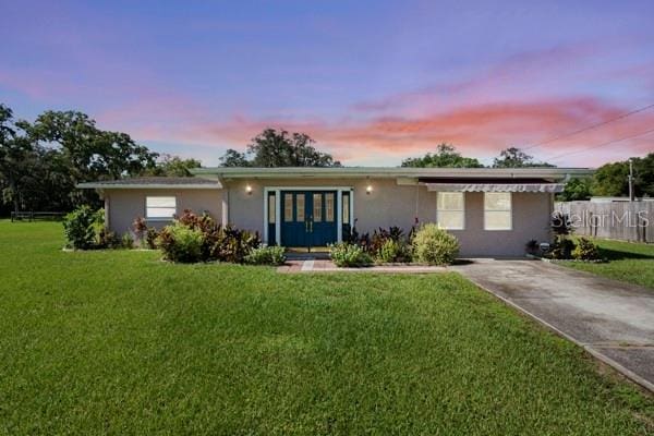 single story home with a front lawn and stucco siding